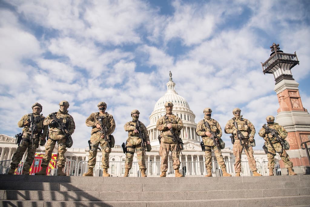 National Guard troops standing post in front of the U.S. Capitol.